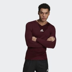 Koszulka piłkarska męska adidas Team Base Tee. Fioletowe bielizna termoaktywna męska Adidas, m, z poliesteru, bez ramiączek, do piłki nożnej. Za 67.99 zł.