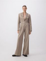 Spodnie z kontrastową wstawką - beżowy. Brązowe spodnie materiałowe damskie Reserved, bez wzorów, z tkaniny. W wyprzedaży za 119.99 zł.