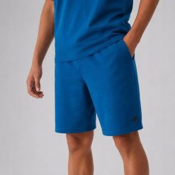 SPODENKI DRESOWE MĘSKIE 4F SPORTOWE TSHOM543 PRZED KOLANO KOLOR ZIELONY. Zielone szorty męskie 4f, na lato, bez wzorów, z bawełny, eleganckie. Za 79.99 zł.