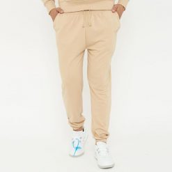 Spodnie sportowe unisex F BALLON beżowe. Brązowe spodnie dresowe damskie Legea, z gumy, na fitness i siłownię. W wyprzedaży za 92.00 zł.