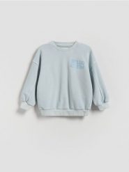 Bluza z efektem sprania - jasnoniebieski. Niebieskie bluzy i bluzki niemowlęce Reserved, bez wzorów, z bawełny, bez ramiączek, bez kaptura. Za 45.99 zł.