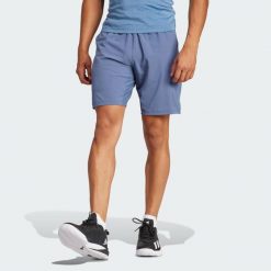 Szorty Tennis Ergo. Niebieskie szorty męskie Adidas, bez wzorów, z elastanu, klasyczne. Za 233.15 zł.