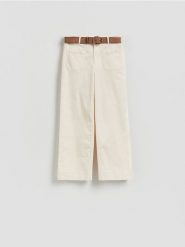 Spodnie z paskiem - kremowy. Białe spodnie materiałowe damskie Reserved, bez wzorów, z bawełny. Za 139.99 zł.