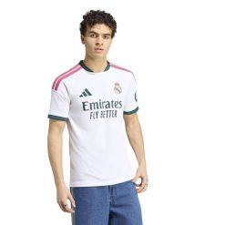 Koszulka piłkarska ADIDAS Real Madryt domowa 2026-2027. Białe bluzki sportowe damskie Adidas, m, bez wzorów, z materiału, bez ramiączek. Za 439.99 zł.