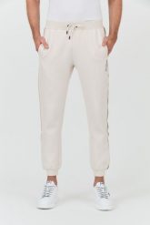 GUESS Beżowe spodnie Mickey Cuff Pant. Brązowe spodnie dresowe męskie Guess, z aplikacjami, z dresówki. W wyprzedaży za 322.99 zł.