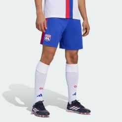 SPODENKI PODSTAWOWE OLYMPIQUE LYONNAIS 26/27. Niebieskie szorty męskie Adidas, bez wzorów, z materiału, klasyczne. Za 199.00 zł.