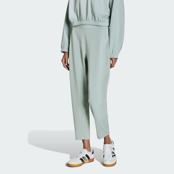 Spodnie All Me Yoga Essentials. Zielone spodnie dresowe damskie Adidas, bez wzorów, z materiału, sportowe. Za 219.00 zł.