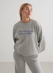 Damska bluza dresowa miękka, luźna, z okrągłym dekoltem Wellness szary melanż. Szare bluzy bez kaptura damskie Aim'n, m, z bawełny. Za 339.00 zł.
