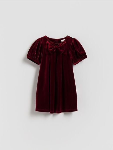 Welurowa sukienka z kokardą - czerwony. Czerwone sukienki dziewczęce Reserved, bez wzorów, z dzianiny, bez ramiączek. Za 69.99 zł.