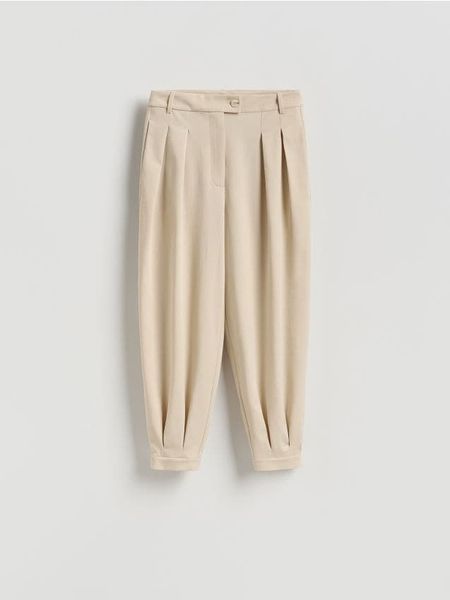 Spodnie balloon - beżowy. Brązowe spodnie materiałowe damskie Reserved, bez wzorów, z tkaniny. Za 139.99 zł.