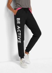 Spodnie sportowe bawełniane z nadrukiem, Loose Fit. Czarne spodnie dresowe damskie bonprix, z bawełny, na fitness i siłownię. Za 114.99 zł.