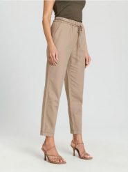 Spodnie carrot - kremowy. Białe spodnie materiałowe damskie Sinsay, bez wzorów, z bawełny. Za 49.99 zł.
