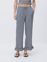 Spodnie z falbanką - granatowy. Niebieskie spodnie materiałowe damskie Reserved, bez wzorów, z dzianiny. Za 89.99 zł.