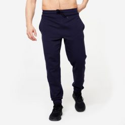 Spodnie dresowe męskie Gym & Pilates - niebieskie. Niebieskie spodnie sportowe męskie DOMYOS, z bawełny. W wyprzedaży za 69.99 zł.