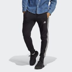 Essentials French Terry Tapered Cuff 3-Stripes Pants. Białe spodnie dresowe męskie Adidas, bez wzorów, z dresówki. Za 182.00 zł.