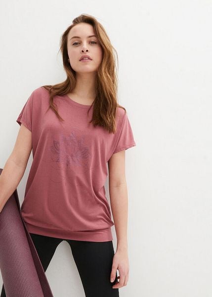 Luźna koszulka sportowa z szerokim ściągaczem u dołu. Fioletowe bluzki sportowe damskie bonprix, bez kołnierzyka, bez ramiączek. Za 62.99 zł.