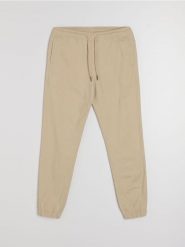 Bawełniane spodnie jogger - beżowy. Brązowe spodnie materiałowe męskie Sinsay, bez wzorów, z bawełny. Za 49.99 zł.