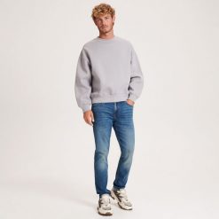Jeansy slim z efektem sprania - indigo jeans. Niebieskie jeansy męskie Reserved. W wyprzedaży za 79.99 zł.