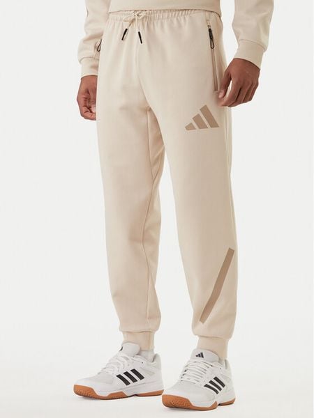 Adidas Spodnie dresowe Z.N.E. KE4684 Beżowy Regular Fit. Brązowe spodnie dresowe męskie Adidas, bez wzorów, z bawełny. Za 399.99 zł.