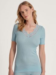 Calida Wełniana koszulka w kolorze błękitnym rozmiar: XS. Niebieskie bluzki damskie Calida, xs, bez wzorów, z koronki, bez kołnierzyka, bez ramiączek. Za 152.62 zł.