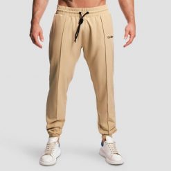 Spodnie męskie fitness jogger beżowe ARC. Brązowe spodnie sportowe męskie GYMBEAM, z elastanu. Za 127.90 zł.
