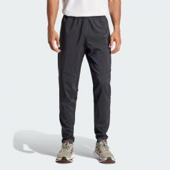 Spodnie Own The Run. Czarne spodnie sportowe męskie Adidas, z materiału. Za 259.00 zł.