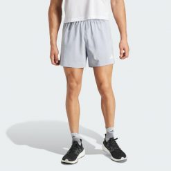 Szorty Own The Run. Szare szorty męskie Adidas, z materiału, bez kołnierzyka. Za 179.00 zł.