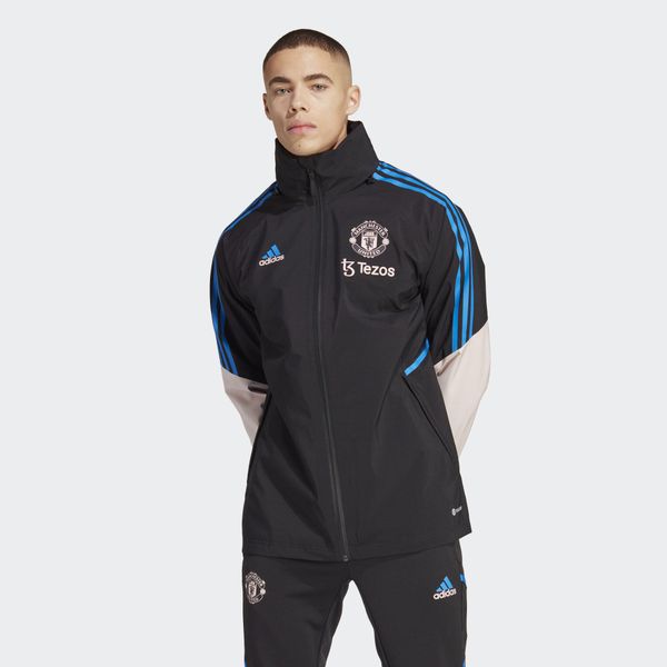 Kurtka do piłki nożnej męska Adidas Manchester United Condivo 22 Storm. Czarne kurtki męskie Adidas, m, bez wzorów, z materiału, sportowe, bez kaptura. W wyprzedaży za 541.50 zł.