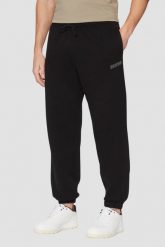 GUESS Czarne męskie spodnie dresowe Emis, Rozmiar M. Czarne spodnie dresowe męskie Guess, z aplikacjami, z bawełny. W wyprzedaży za 236.99 zł.