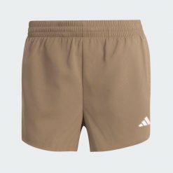 Szorty do ćwiczeń Essentials 2in1. Zielone spodenki sportowe damskie Adidas, bez wzorów, z elastanu, eleganckie, z standardowym stanem. Za 179.00 zł.