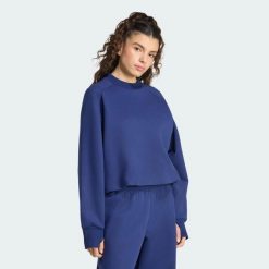 Bluza z dzianiny Soft Lux Winter. Niebieskie bluzy z nadrukiem damskie Adidas, xs, z bawełny. Za 299.00 zł.