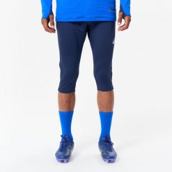 Spodnie piłkarskie 3/4 Kipsta CLR. Niebieskie spodnie materiałowe męskie KIPSTA, bez wzorów, z elastanu, sportowe. Za 89.99 zł.