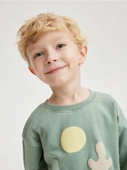 Bluza z aplikacją - jasnozielony. Zielone bluzy i bluzki niemowlęce Reserved, z aplikacjami, z bawełny, bez ramiączek, bez kaptura. W wyprzedaży za 22.99 zł.