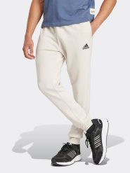 Adidas Spodnie dresowe w kolorze kremowym rozmiar: XL. Brązowe spodnie dresowe damskie Adidas, bez wzorów, z dresówki. Za 190.18 zł.