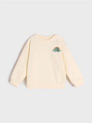 Bluza niemowlęca - kremowy. Białe bluzy i bluzki niemowlęce Sinsay, bez wzorów, z bawełny, bez ramiączek, długie, bez kaptura. Za 17.99 zł.