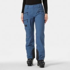 Spodnie narciarskie dla kobiet Helly Hansen Powderqueen. Niebieskie spodnie materiałowe damskie Helly Hansen, bez wzorów, z puchu, sportowe. Za 1,190.50 zł.