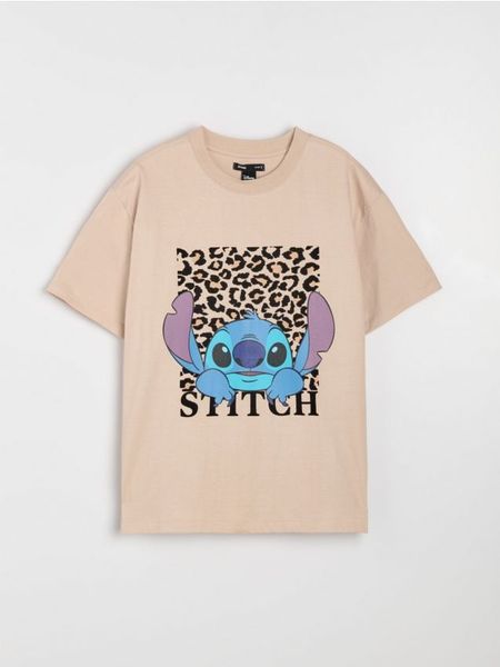 Bawełniana koszulka z nadrukiem Stitch - beżowy. Brązowe t-shirty damskie Sinsay, l, bez wzorów, z bawełny, bez kołnierzyka. Za 39.99 zł.