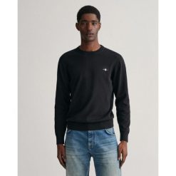 Sweter męski GANT z klasycznym okrągłym dekoltem. Czarne swetry męskie Gant, m, bez wzorów, z bawełny, bez kołnierzyka. Za 562.50 zł.