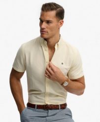 Superdry Koszula Preppy Oxford krótki rękaw z organicznej bawełny. Żółte koszule damskie Superdry., l, bez wzorów, z bawełny, klasyczne, bez kołnierzyka, bez ramiączek. Za 301.95 zł.