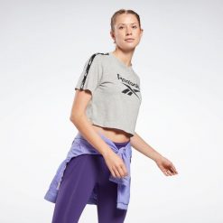 Koszulka z krótkim rękawem damska Reebok Gym & Pilates. Szare bluzki damskie Reebok, l, z bawełny, bez kołnierzyka, bez ramiączek. W wyprzedaży za 69.99 zł.