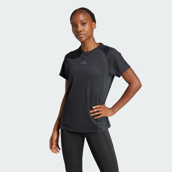 Bezszwowa koszulka z dzianiny. Czarne bluzki damskie Adidas, bez wzorów, z dzianiny, bez kołnierzyka. Za 199.00 zł.