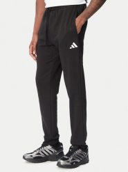 Adidas Spodnie dresowe Essentials Feelcozy JE3815 Czarny Regular Fit. Czarne spodnie dresowe męskie Adidas, bez wzorów, z bawełny. Za 219.99 zł.