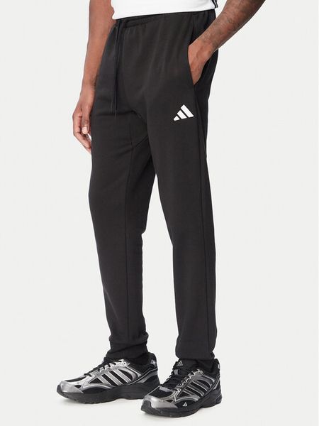 Adidas Spodnie dresowe Essentials Feelcozy JE3815 Czarny Regular Fit. Czarne spodnie dresowe męskie Adidas, bez wzorów, z bawełny. Za 219.99 zł.