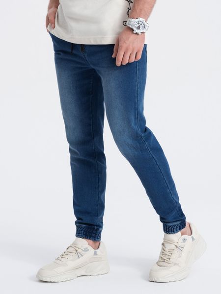 Spodnie męskie jeansowe JOGGER SLIM FIT - ciemnoniebieskie V3 - Rozmiar: XL. Niebieskie spodnie materiałowe męskie Ombre Clothing, bez wzorów, z bawełny. W wyprzedaży za 79.99 zł.