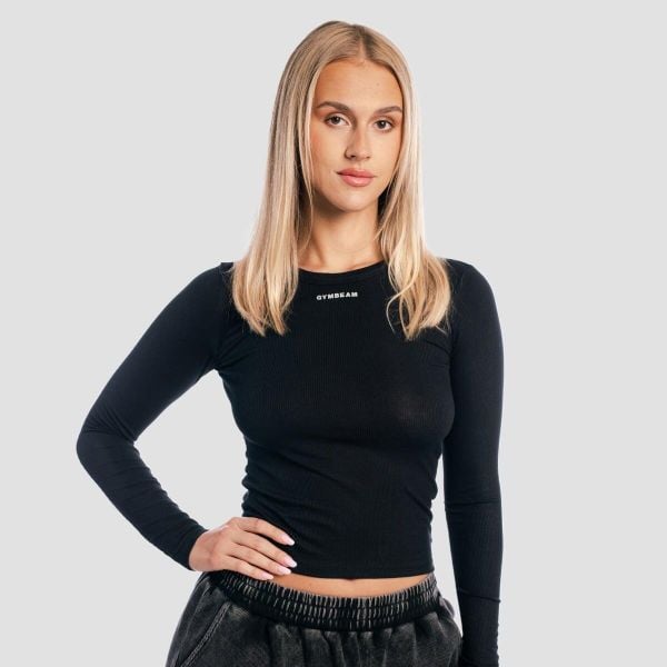 Koszulka damska fitness z długim rękawem slim czarna Aura. Czarne bluzki sportowe damskie GYMBEAM, uniwersalny, bez wzorów, z elastanu, bez ramiączek. Za 106.90 zł.
