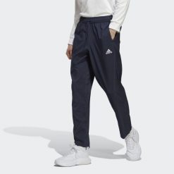 Spodnie AEROREADY Essentials Stanford Open Hem Embroidered Small Logo. Niebieskie spodnie sportowe męskie Adidas, z materiału. W wyprzedaży za 160.05 zł.
