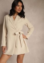 Beżowa Sukienka Kopertowa Ozdobiona Imitacją Kieszeni Davirnas. Brązowe sukienki damskie Renee, l, bez wzorów, eleganckie, bez kołnierzyka, bez ramiączek, mini, kopertowe. Za 89.99 zł.