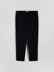 Spodnie chino slim fit - czarny. Czarne spodnie materiałowe męskie Reserved, bez wzorów, z bawełny. W wyprzedaży za 89.99 zł.