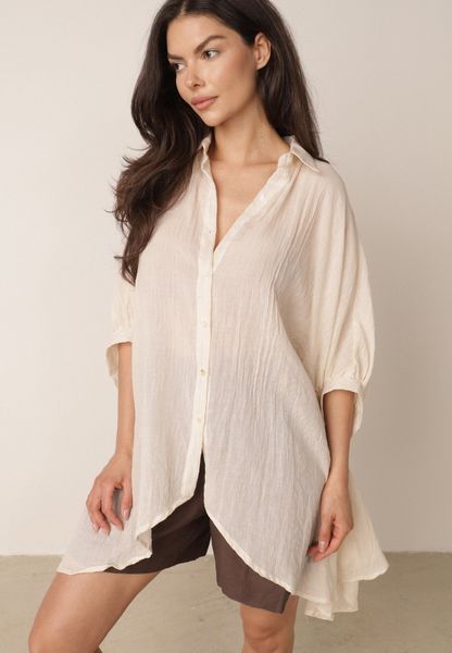Beżowa Zwiewna Koszula Letnia Oversize z Bawełny o Nietoperzowym Kroju Canomela. Brązowe koszule damskie Born2be, na lato, l, bez wzorów, z bawełny, eleganckie, bez kołnierzyka, bez ramiączek. Za 139.99 zł.