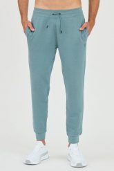 GUESS Patynowe spodnie dresowe. Zielone spodnie dresowe męskie Guess, z aplikacjami, z dresówki. W wyprzedaży za 229.99 zł.